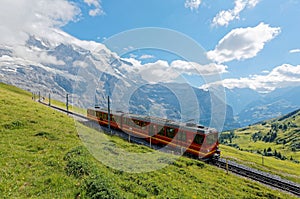 A cog wheel train traveling on famous Jungfrau Railway from Jungfraujoch station top of Europe photo