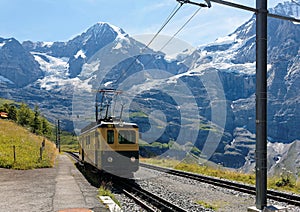 A cog wheel train traveling on the mountain Railway from Wengen to Kleine Scheidegg station