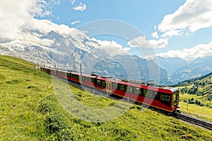 A cog wheel train travels on famous Jungfrau Railway from Kleine Scheidegg to Jungfraujoch station