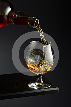 Cognac or brandy being poured into a glass