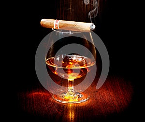 Cognac and cigar. Glass of brandy