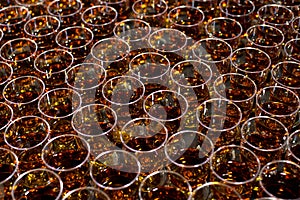 Cognac in glasses. A large number of glasses.
