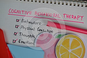 Cognitive Behavioral Therapy write on a book with keywords isolated on Wooden Table. Chart or mechanism concept