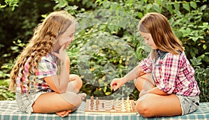 Cognitive development. Intellectual game. Make decision. Smart children. Children play chess outdoors nature background photo