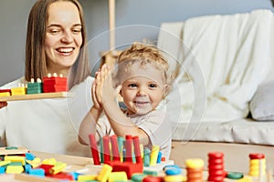 Cognitive development puzzles. Montessori learning approach. Fun family activities. teacher or mother playing with baby with