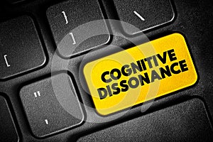 Cognitive Dissonance is the perception of contradictory information, and the mental toll of it, text button on keyboard, concept