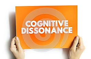 Cognitive Dissonance is the perception of contradictory information, and the mental toll of it, text concept on card photo