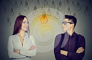 Cognitive skills concept, male vs female. Man and woman looking at light bulb photo