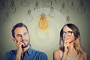Cognitive skills male vs female. Man and woman looking at light bulb