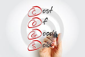 COGS - Cost of Goods Sold acronym with marker, business concept background