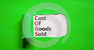 COGS cost of goods sold symbol. Concept words COGS cost of goods sold on white paper on beautiful green background. Business COGS