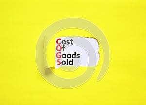 COGS cost of goods sold symbol. Concept words COGS cost of goods sold on white paper on beautiful yellow background. Business COGS