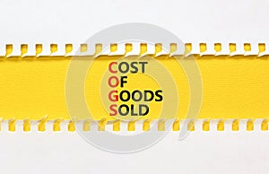 COGS cost of goods sold symbol. Concept words COGS cost of goods sold on yellow paper on beautiful white background. Business COGS