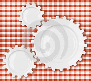 Cogs and gears plates over red picnic tablecloth