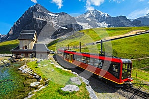 Cogwheel tourist train coming down from the mountain, Jungfraujoch, Switzerland photo