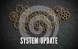 Cogwheels and the words `system update` on slate background