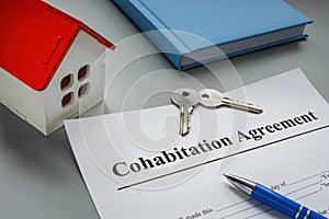 Cohabitation agreement, keys and model of home. photo