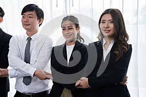 Cohesive office workers holding hand in line to promote harmony in workplace.