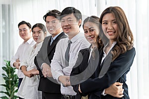 Cohesive office workers holding hand in line to promote harmony in workplace.