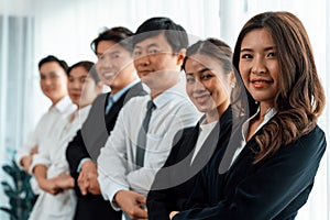 Cohesive office workers holding hand in line to promote harmony in workplace.