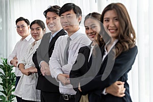 Cohesive office workers holding hand in line to promote harmony in workplace.