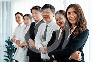 Cohesive office workers holding hand in line to promote harmony in workplace.