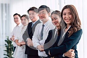 Cohesive office workers holding hand in line to promote harmony in workplace.