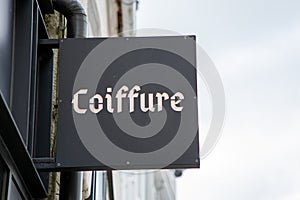 coiffure french text hairstyle translated into hairdresser barber shop on sign wall facade