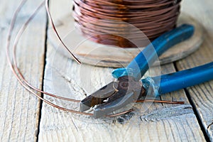 Coil of copper wire and pliers