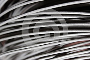 A coil of fechral thick refractory wire hangs in a warehouse of goods for ceramists. Frame of coiled nichrome wire for photo