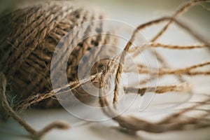 A coil of fluffy beige hemp rope with a tangled end