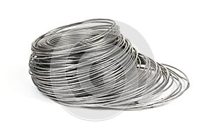 Coil of galvanized wires lying on white background. High resolution photo
