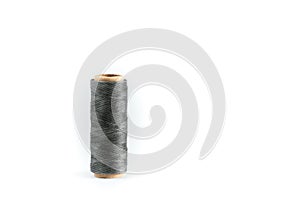 A coil of gray thread. Spool of colored threads on a white background. Waxed sewing thread for leather crafts.