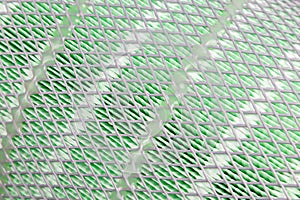 The coil of the new cargo air filter, made of green material covered with white mesh, cleans the air flow from dirt. Close-up.