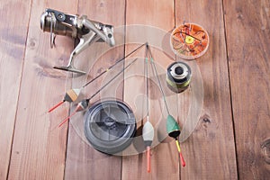 Coil, spools of fishing line, floats and a box of hooks