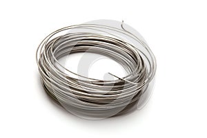 Coil of stainless steel wire isolated on white background.