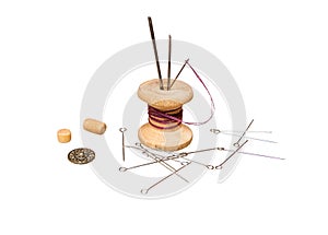 The coil with threads, needles, button and beads isolated on a white background
