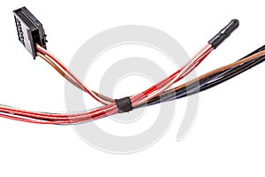 A coil of wires of two different colors connecting different electronic systems rewound with electrical tape with connectors on a