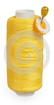 The coil of yellow thread with the yellow button on pin