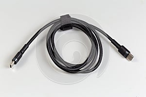 Coiled black cable USB Type-C on a gray background photo