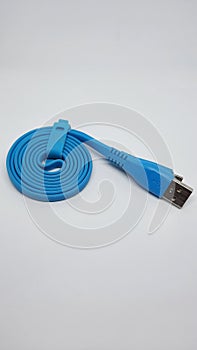 Coiled blue micro usb cable isolated on white background