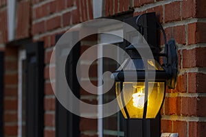 A coiled compact fluorescent light bulb glowing in dark.