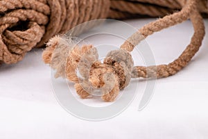 Coiled jute rope selective focus of frayed knot ends