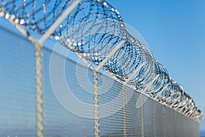 Coiled razor wire on top of a fence