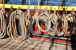 Coiled rope lines stored on belaying pins