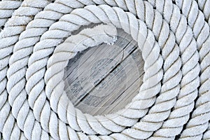 Coiled rope sits on a an old wooddn dock