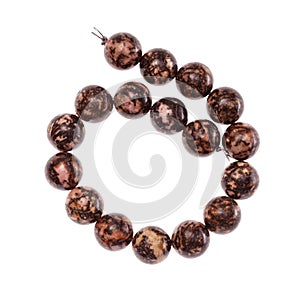 Coiled string of beads from rhodonite gemstone