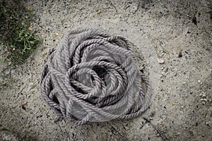 Coiled thick braided gray rope
