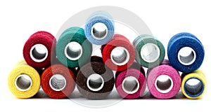 Coils of colored thread on a white background
