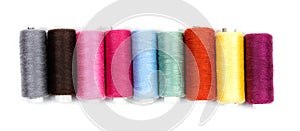 Coils of colored thread on a white background
